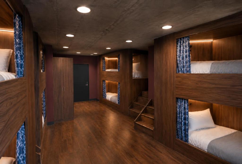 Bunks in a group dorm, with stairs up to the top beds